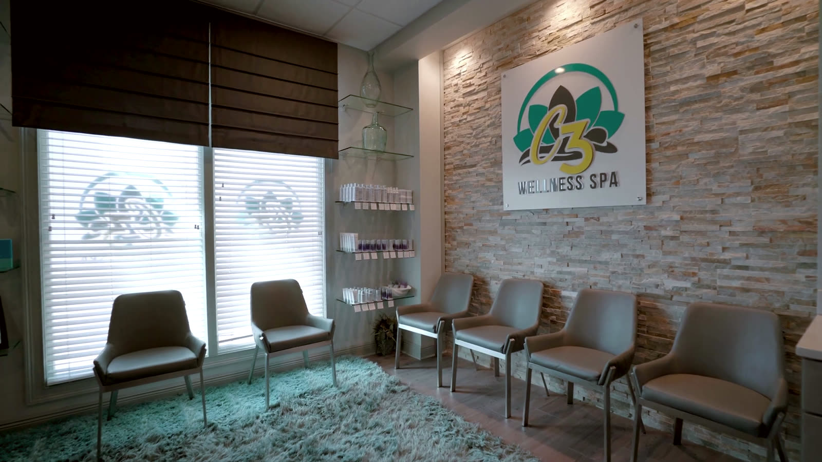 Reception with stone wall and C3 Wellness Spa sign